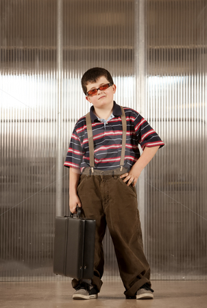 To use this stock image in your creative project, please select the size you need over to the right and click the "Add to Cart" button.
Your downloaded image will come with the Cutcaster watermark removed so don’t worry about the watermark you see on this page. Little boy in adult clothes stock photo, Handsome young boy in adult business clothes by Scott Griessel