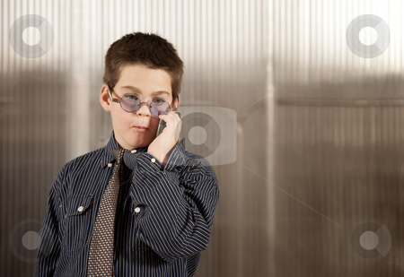 To use this stock image in your creative project, please select the size you need over to the right and click the "Add to Cart" button.
Your downloaded image will come with the Cutcaster watermark removed so don’t worry about the watermark you see on this page. Little boy in adult clothes on cell phone stock photo, Handsome young boy in adult business clothes on phone by Scott Griessel