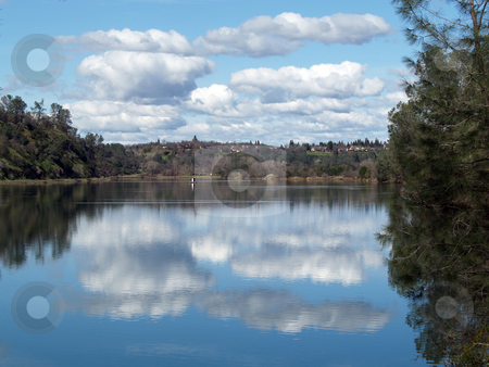 To use this stock image in your creative project, please select the size you need over to the right and click the "Add to Cart" button.
Your downloaded image will come with the Cutcaster watermark removed so don’t worry about the watermark you see on this page. White clouds and blue sky reflected in lake stock photo, Sky, clouds, trees and shore reflected in lake by Jeff Cleveland