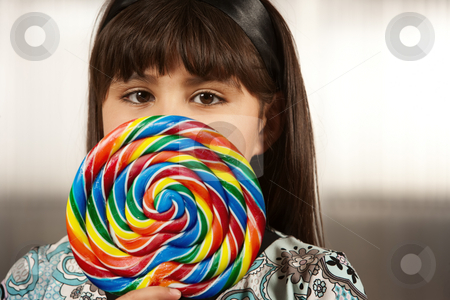 To use this stock image in your creative project, please select the size you need over to the right and click the "Add to Cart" button.
Your downloaded image will come with the Cutcaster watermark removed so don’t worry about the watermark you see on this page. Cute young girl with lollipop stock photo, Cute young Hispanic girl with a lollipop by Scott Griessel