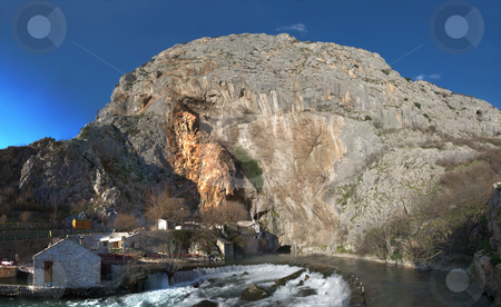 To use this stock image in your creative project, please select the size you need over to the right and click the "Add to Cart" button.
Your downloaded image will come with the Cutcaster watermark removed so don’t worry about the watermark you see on this page. Panorama of Buna River Source stock photo, Panorama of the Buna river source near Mostar in Bosnia and Herzegovina with water coming out of a cave. Just above the cave is an old muslim school turned in a national monument. by Denis Radovanovic