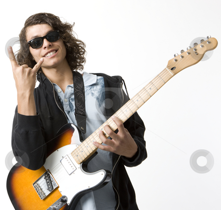 To use this stock image in your creative project, please select the size you need over to the right and click the "Add to Cart" button.
Your downloaded image will come with the Cutcaster watermark removed so don’t worry about the watermark you see on this page. Boy with guitar gestures stock photo, A boy with an electric guitar smiles and gestures by Rick Becker-Leckrone