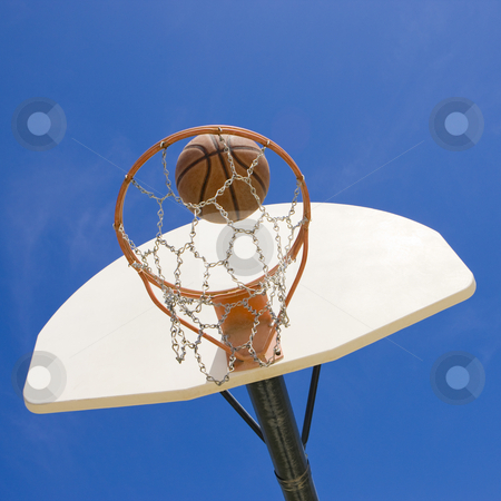 To use this stock image in your creative project, please select the size you need over to the right and click the "Add to Cart" button.
Your downloaded image will come with the Cutcaster watermark removed so don’t worry about the watermark you see on this page. Basketball hoop and ball stock photo, A basketball goes through a basketball hoop by Rick Becker-Leckrone