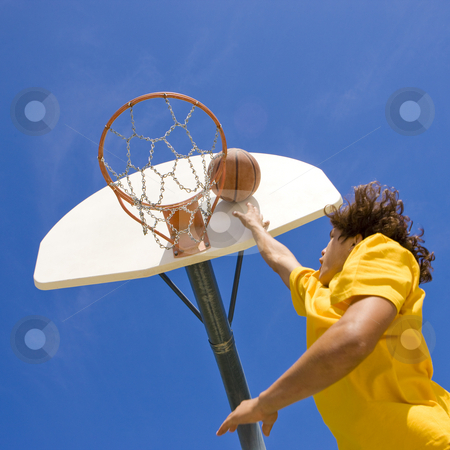 To use this stock image in your creative project, please select the size you need over to the right and click the "Add to Cart" button.
Your downloaded image will come with the Cutcaster watermark removed so don’t worry about the watermark you see on this page. Basketball player jumps and shoots stock photo, A teen basketball player jumps and shoots by Rick Becker-Leckrone