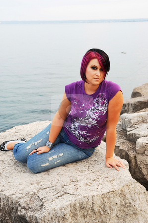 To use this stock image in your creative project, please select the size you need over to the right and click the "Add to Cart" button.
Your downloaded image will come with the Cutcaster watermark removed so don’t worry about the watermark you see on this page. Girl sitting on lakeshore. stock photo, An red hair girl in jeans sitting on the shore of lake Ontario at sunset. by Horst Petzold