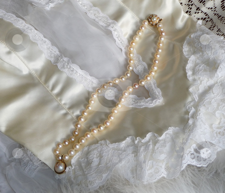 To use this stock image in your creative project, please select the size you need over to the right and click the "Add to Cart" button.
Your downloaded image will come with the Cutcaster watermark removed so don’t worry about the watermark you see on this page. White satin lingerie and string of pearls stock photo, Romantic setting of white satin and lace lingerie and string of pearls by Jill Reid