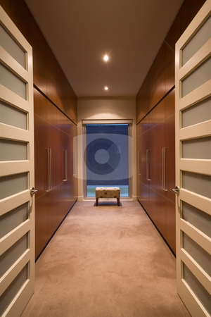 To use this stock image in your creative project, please select the size you need over to the right and click the "Add to Cart" button.
Your downloaded image will come with the Cutcaster watermark removed so don’t worry about the watermark you see on this page. Walk in wardrobe stock photo, A spacious luxury walk in wardrobe featuring modern style joinery by Angus Benham