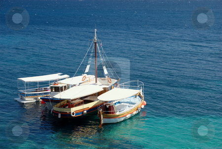 To use this stock image in your creative project, please select the size you need over to the right and click the "Add to Cart" button.
Your downloaded image will come with the Cutcaster watermark removed so don’t worry about the watermark you see on this page. Taxi boats stock photo, Tourist taxi boats on mediterranean sea - beach