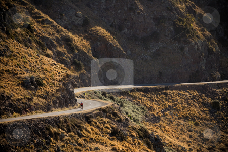 To use this stock image in your creative project, please select the size you need over to the right and click the "Add to Cart" button.
Your downloaded image will come with the Cutcaster watermark removed so don’t worry about the watermark you see on this page. Cycle road stock photo, A cyclist on a winding road by Angus Benham
