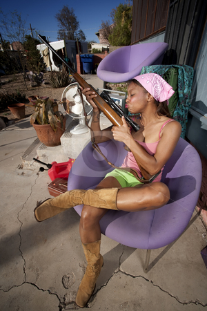 To use this stock image in your creative project, please select the size you need over to the right and click the "Add to Cart" button.
Your downloaded image will come with the Cutcaster watermark removed so don’t worry about the watermark you see on this page. Black woman on back patio kissing rifle stock photo, Black woman kissing rifle in front of house with messy yard by Scott Griessel