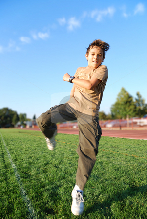 To use this stock image in your creative project, please select the size you need over to the right and click the "Add to Cart" button.
Your downloaded image will come with the Cutcaster watermark removed so don’t worry about the watermark you see on this page. Boy in Action stock photo, Teenage boy jumping in a green grass covered sports field on a sunny day. by Denis Radovanovic