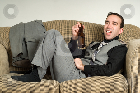 To use this stock image in your creative project, please select the size you need over to the right and click the "Add to Cart" button.
Your downloaded image will come with the Cutcaster watermark removed so don’t worry about the watermark you see on this page. Relaxing After Work stock photo, A young businessman relaxing after work with a beer, while sitting on the sofa at home by Richard Nelson