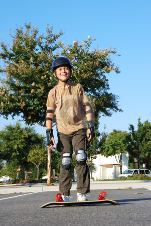 To use this stock image in your creative project, please select the size you need over to the right and click the "Add to Cart" button.
Your downloaded image will come with the Cutcaster watermark removed so don’t worry about the watermark you see on this page. Having Fun With Skateboard stock photo, Teenage boy smiling with a skateboard on the ground on a sunny day with blue sky and trees in the background. by Denis Radovanovic