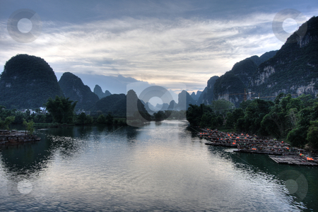 To use this stock image in your creative project, please select the size you need over to the right and click the "Add to Cart" button.
Your downloaded image will come with the Cutcaster watermark removed so don’t worry about the watermark you see on this page. Mountain landscape stock photo, Li river karst mountain landscape in Yangshuo, China by Christopher Meder