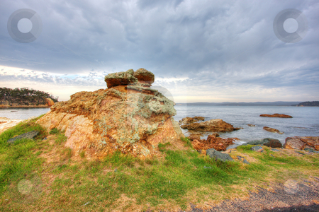 To use this stock image in your creative project, please select the size you need over to the right and click the "Add to Cart" button.
Your downloaded image will come with the Cutcaster watermark removed so don’t worry about the watermark you see on this page. Beachside Boulder stock photo, Beachside boulder against blue sky and green grass by Christopher Meder
