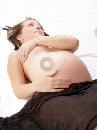 To use this stock image in your creative project, please select the size you need over to the right and click the "Add to Cart" button.
Your downloaded image will come with the Cutcaster watermark removed so don’t worry about the watermark you see on this page. Young blond pregnant woman bare belly on floor stock photo, Young caucasian pregnant woman bare belly on back by Jeff Cleveland