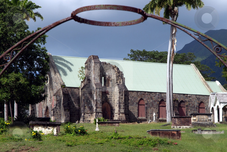 To use this stock image in your creative project, please select the size you need over to the right and click the "Add to Cart" button.
Your downloaded image will come with the Cutcaster watermark removed so don’t worry about the watermark you see on this page. Iron halo over stone church and cemetery in St. Kitts stock photo, Old stone church and cemetery framed by iron gate and steel halo by Jill Reid