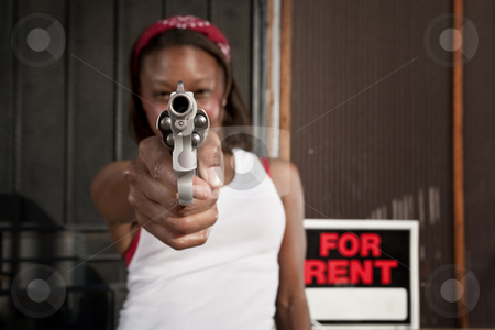 To use this stock image in your creative project, please select the size you need over to the right and click the "Add to Cart" button.
Your downloaded image will come with the Cutcaster watermark removed so don’t worry about the watermark you see on this page. Woman with Gun stock photo, African American woman with a gun on her front porch by Scott Griessel