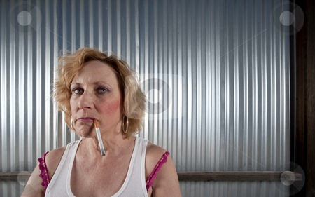 To use this stock image in your creative project, please select the size you need over to the right and click the "Add to Cart" button.
Your downloaded image will come with the Cutcaster watermark removed so don’t worry about the watermark you see on this page. Woman smoking in front of corrugated metal stock photo, Woman smoking cigarette in front of corrugated metal by Scott Griessel