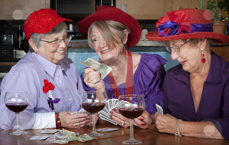 To use this stock image in your creative project, please select the size you need over to the right and click the "Add to Cart" button.
Your downloaded image will come with the Cutcaster watermark removed so don’t worry about the watermark you see on this page. Ladies wearing red hats playing cards stock photo, Ladies wearing red hats playing a hand of cards by Scott Griessel
