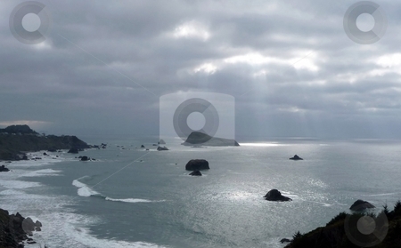 To use this stock image in your creative project, please select the size you need over to the right and click the "Add to Cart" button.
Your downloaded image will come with the Cutcaster watermark removed so don’t worry about the watermark you see on this page. Light from the heavens stock photo, Sunlight streams through heavy clouds and lights up the surface of the ocean by Jill Reid