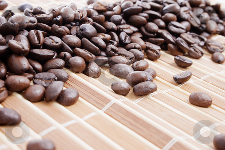To use this stock image in your creative project, please select the size you need over to the right and click the "Add to Cart" button.
Your downloaded image will come with the Cutcaster watermark removed so don’t worry about the watermark you see on this page. Coffee beans on bamboo placemat stock photo, Coffee beans on bamboo placemat - focus on center by iodrakon