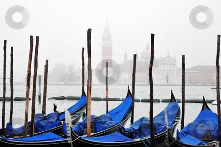 To use this stock image in your creative project, please select the size you need over to the right and click the "Add to Cart" button.
Your downloaded image will come with the Cutcaster watermark removed so don’t worry about the watermark you see on this page. Venice gondolas in fog stock photo, Venice gondolas in fog with grand canal in background by Jaime Pharr