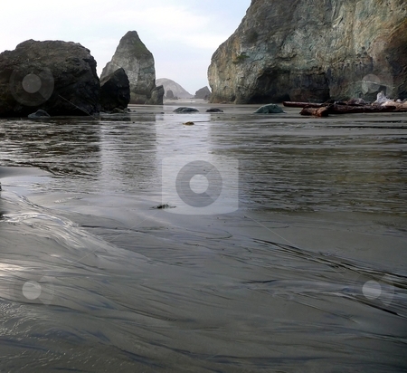 To use this stock image in your creative project, please select the size you need over to the right and click the "Add to Cart" button.
Your downloaded image will come with the Cutcaster watermark removed so don’t worry about the watermark you see on this page. Riptide at Rainbow Rock formation in Oregon stock photo, Riptide across the beach at Rainbow Rock formation and cliffs in Oregon by Jill Reid