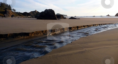 To use this stock image in your creative project, please select the size you need over to the right and click the "Add to Cart" button.
Your downloaded image will come with the Cutcaster watermark removed so don’t worry about the watermark you see on this page. Riptide carves a river on the beach stock photo, A rushing riptide carves a river through the beach on the way to the shore in Oregon by Jill Reid
