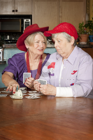 To use this stock image in your creative project, please select the size you need over to the right and click the "Add to Cart" button.
Your downloaded image will come with the Cutcaster watermark removed so don’t worry about the watermark you see on this page. Ladies wearing red hats playing cards stock photo, Ladies wearing red hats playing a hand of cards by Scott Griessel