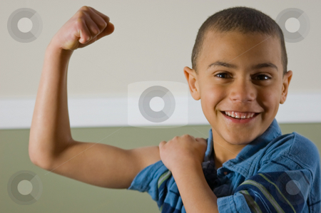 To use this stock image in your creative project, please select the size you need over to the right and click the "Add to Cart" button.
Your downloaded image will come with the Cutcaster watermark removed so don’t worry about the watermark you see on this page. 9 Year Old Multi Racial Boy Showing Off His Muscles stock photo, Cute 9 year old multi racial boy is proudly showing off his muscles while giving a winning smile. by Valerie Garner