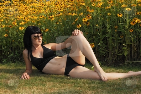 To use this stock image in your creative project, please select the size you need over to the right and click the "Add to Cart" button.
Your downloaded image will come with the Cutcaster watermark removed so don’t worry about the watermark you see on this page. Pretty girl in bikini. stock photo, Young beautiful woman in an black bikini sitting in front of a field of yellow
flowers in the sunset. by Horst Petzold