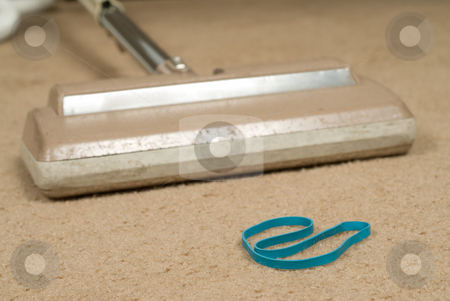 To use this stock image in your creative project, please select the size you need over to the right and click the "Add to Cart" button.
Your downloaded image will come with the Cutcaster watermark removed so don’t worry about the watermark you see on this page. Sucking Up An Elastic stock photo, Closeup view of an elastic band in the way of a vacuum cleaner by Richard Nelson
