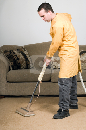 To use this stock image in your creative project, please select the size you need over to the right and click the "Add to Cart" button.
Your downloaded image will come with the Cutcaster watermark removed so don’t worry about the watermark you see on this page. Vacuuming stock photo, A man wearing a work coat and vacuuming the carpets inside a house by Richard Nelson