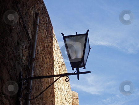 To use this stock image in your creative project, please select the size you need over to the right and click the "Add to Cart" button.
Your downloaded image will come with the Cutcaster watermark removed so don’t worry about the watermark you see on this page. Lamp and brick wall in Tuscany stock photo, Lamp and brick wall in Tuscany Italy by Jaime Pharr