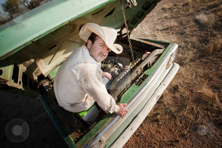 To use this stock image in your creative project, please select the size you need over to the right and click the "Add to Cart" button.
Your downloaded image will come with the Cutcaster watermark removed so don’t worry about the watermark you see on this page. Man under the hood of his truck stock photo, Man in cowboy hat under the hood of truck by Scott Griessel