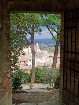To use this stock image in your creative project, please select the size you need over to the right and click the "Add to Cart" button.
Your downloaded image will come with the Cutcaster watermark removed so don’t worry about the watermark you see on this page. San Gimignano through doorway stock photo, View of San Gimignano through garden doorway by Jaime Pharr