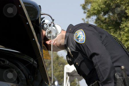 To use this stock image in your creative project, please select the size you need over to the right and click the "Add to Cart" button.
Your downloaded image will come with the Cutcaster watermark removed so don’t worry about the watermark you see on this page. Policaman at aCar show stock photo, Police Office looking at the interior of a vintage car in a car show in Los Angeles by Didier Tais
