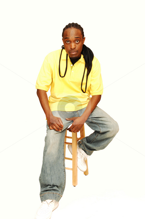To use this stock image in your creative project, please select the size you need over to the right and click the "Add to Cart" button.
Your downloaded image will come with the Cutcaster watermark removed so don’t worry about the watermark you see on this page. Young African American man. stock photo, Young African American sitting on an bar chair in the studio for white
background. by Horst Petzold
