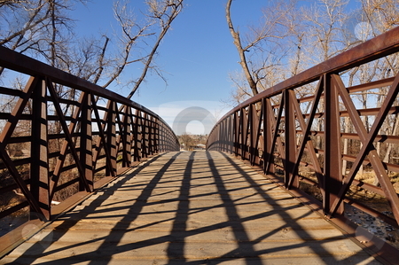 To use this stock image in your creative project, please select the size you need over to the right and click the "Add to Cart" button.
Your downloaded image will come with the Cutcaster watermark removed so don’t worry about the watermark you see on this page. Old Metal Footbridge stock photo, An old metal bridge stands under a blue Colorado sky in the winter with trees in the background. There is space for copy. by Ben O'Neal