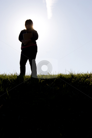 To use this stock image in your creative project, please select the size you need over to the right and click the "Add to Cart" button.
Your downloaded image will come with the Cutcaster watermark removed so don’t worry about the watermark you see on this page. Student Silhouette stock photo, A young college student posing with her backpack on campus at sunset. This works great as inspirational imagery for educational marketing materials. by Todd Arena