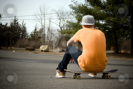 To use this stock image in your creative project, please select the size you need over to the right and click the "Add to Cart" button.
Your downloaded image will come with the Cutcaster watermark removed so don’t worry about the watermark you see on this page. Skateboarder stock photo, A young skater resting on his board. by Todd Arena
