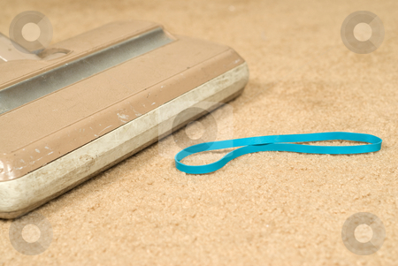 To use this stock image in your creative project, please select the size you need over to the right and click the "Add to Cart" button.
Your downloaded image will come with the Cutcaster watermark removed so don’t worry about the watermark you see on this page. Vacuuming The Carpet stock photo, Closeup view of a vacuum cleaner about to suck up an elastic band on the carpet by Richard Nelson