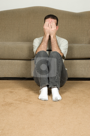 To use this stock image in your creative project, please select the size you need over to the right and click the "Add to Cart" button.
Your downloaded image will come with the Cutcaster watermark removed so don’t worry about the watermark you see on this page. Depressed Man stock photo, A depressed man covering his face and sitting on the floor near the sofa by Richard Nelson