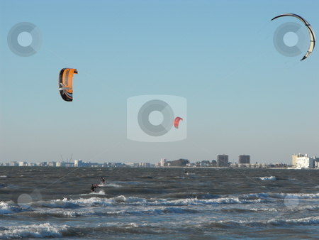 To use this stock image in your creative project, please select the size you need over to the right and click the "Add to Cart" button.
Your downloaded image will come with the Cutcaster watermark removed so don’t worry about the watermark you see on this page. Kite boarding stock photo, Kite boarders ride the late afternoon wind along the Gulf Coast by St. Pete's Beach in Florida on a winter day. by Dennis Thomsen