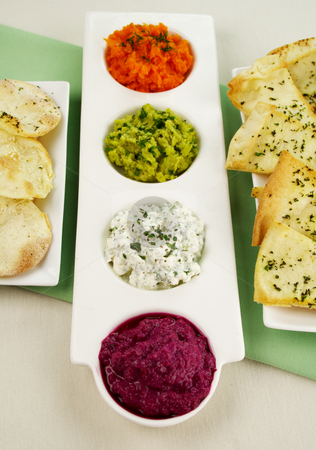 To use this stock image in your creative project, please select the size you need over to the right and click the "Add to Cart" button.
Your downloaded image will come with the Cutcaster watermark removed so don’t worry about the watermark you see on this page. Assorted Dips stock photo, Assorted dips of beetroot, carrot, cottage cheese and herbs, pea and basil with pita crisps. by Brett Mulcahy