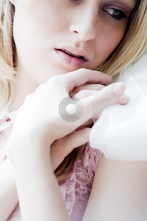To use this stock image in your creative project, please select the size you need over to the right and click the "Add to Cart" button.
Your downloaded image will come with the Cutcaster watermark removed so don’t worry about the watermark you see on this page. Hands en face stock photo, Young blond girl posing in lightpink lingerie nearby a bright window by Frenk and Danielle Kaufmann