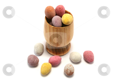 To use this stock image in your creative project, please select the size you need over to the right and click the "Add to Cart" button.
Your downloaded image will come with the Cutcaster watermark removed so don’t worry about the watermark you see on this page. Easter Eggcup from above stock photo, Small wooden eggcup filled with candy coated chocolate Easter Eggs by Helen Shorey