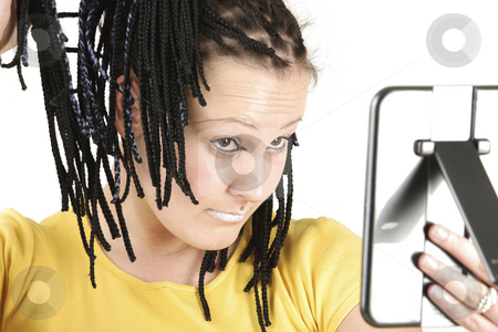 To use this stock image in your creative project, please select the size you need over to the right and click the "Add to Cart" button.
Your downloaded image will come with the Cutcaster watermark removed so don’t worry about the watermark you see on this page. Mirror look stock photo, Young girl is checking her selves in mirror by Tom P.