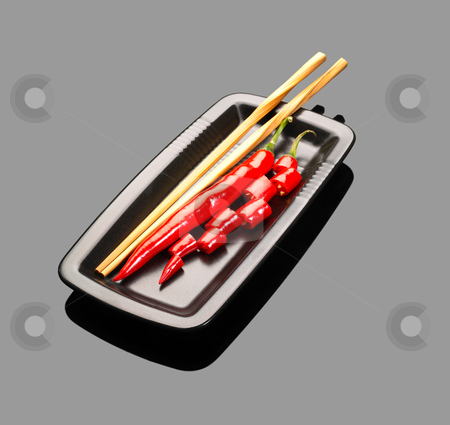 To use this stock image in your creative project, please select the size you need over to the right and click the "Add to Cart" button.
Your downloaded image will come with the Cutcaster watermark removed so don’t worry about the watermark you see on this page. Red chili peppers stock photo, Fresh red chili peppers on a plate with chopstikcs over grey reflective surface by Francesco Perre